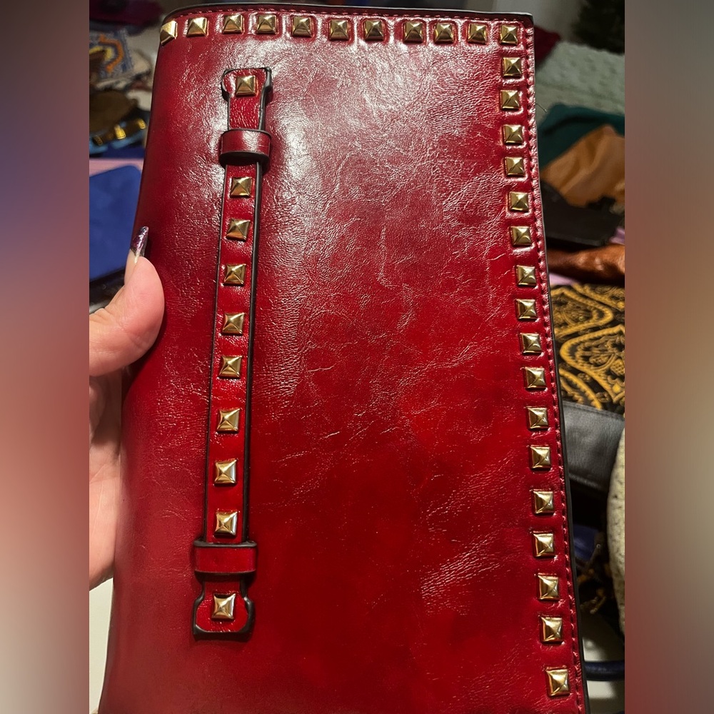 Call clutch color is burgundy the sunlight has a hint of red flex leather